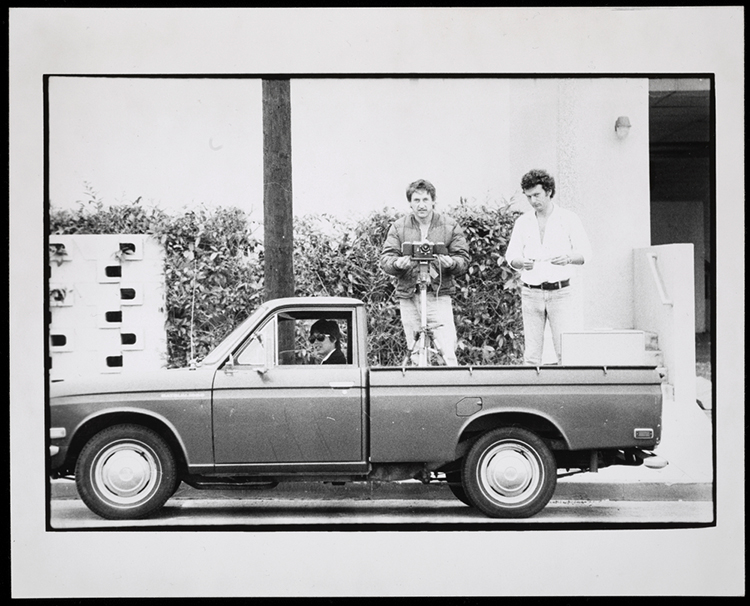 Ed Ruscha, Bryan Heath, and Danny Kwan in Ruscha's Datsun pickup truck during shoot of Sunset Blvd, August 1975